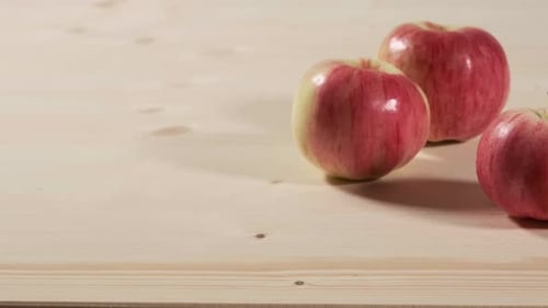Three Red Apples On a Wooden Table