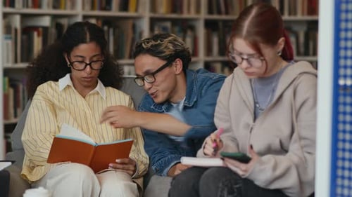 Asian Gen Z Student Helping His Biracial Classmate with Assignment in Library