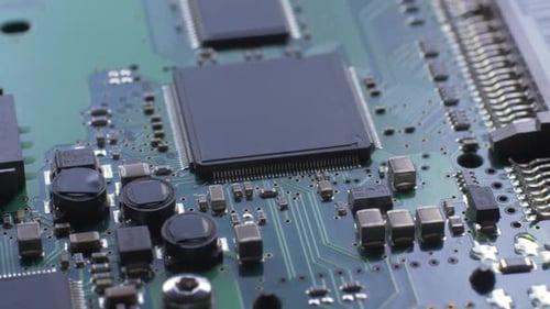 Green Electronic Circuit Board with Processor Chips and Capacitors