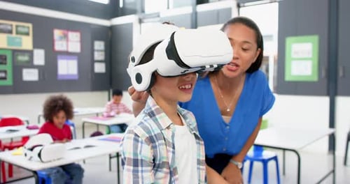 In school, teacher helping student using VR headset in classroom activity