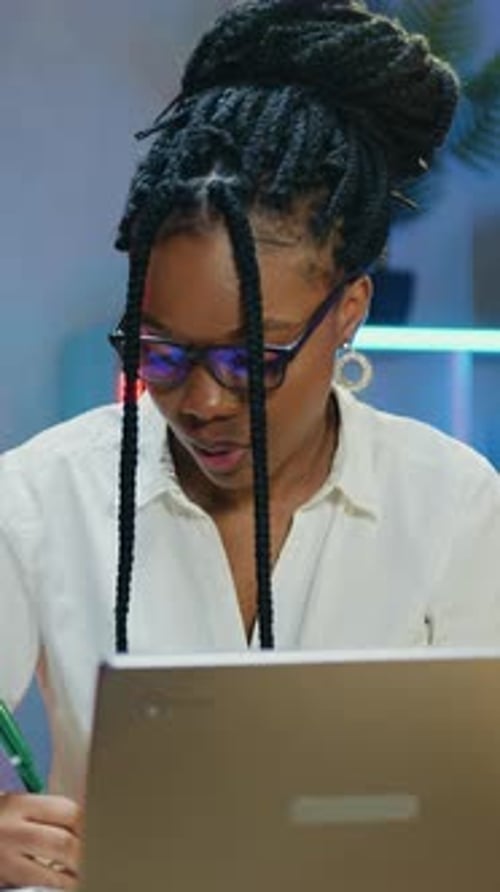 Woman Working on Laptop in Modern Office