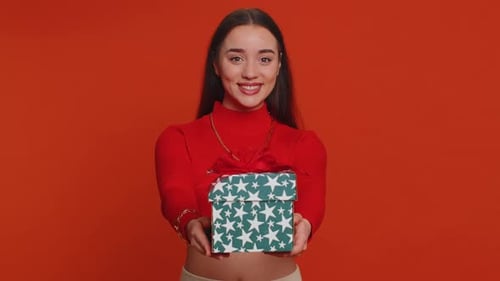 Smiling Young Woman Holding Gift Box