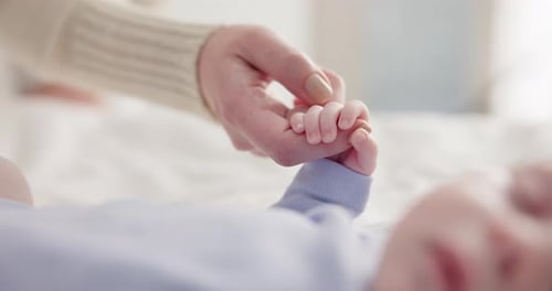 Mother Holding Her Baby's Hand