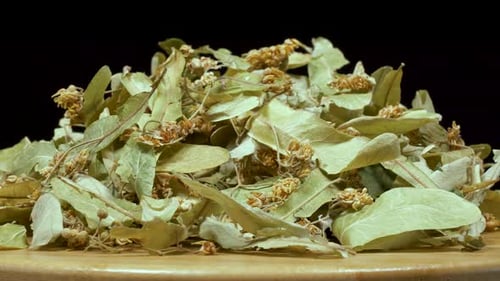 Dried Linden Flowers on Wooden Surface Rotating Slowly