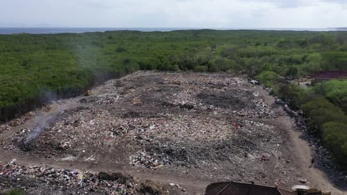 Rubbish tip, landfill, waste area in Lembongan Bali drone medium pans shot