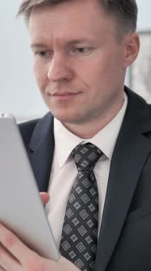 Businessman Using Tablet Device Indoors
