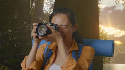 Close Up Of Asian Female Hiker Using A Camera Taking Picture While Exploring Forest Nature