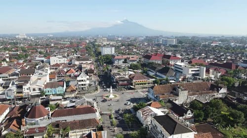 Aerial view of the Yogyakarta monument on a sunny morning with a blue sky, Mount Merapi in the backg
