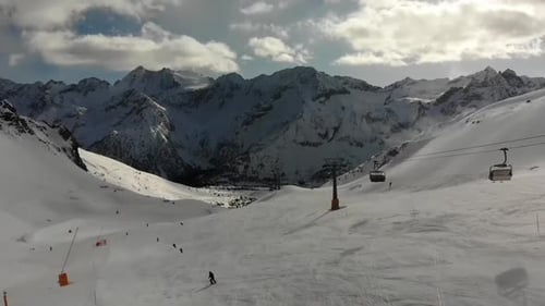 Aerial video of a cable car and people snowboarding and skiing in South Tyrol