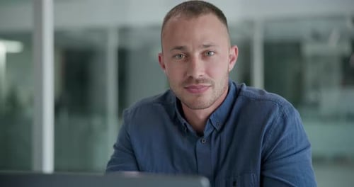 Smiling Man in Blue Shirt in Office