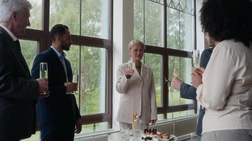 Business colleagues toasting with champagne at corporate event