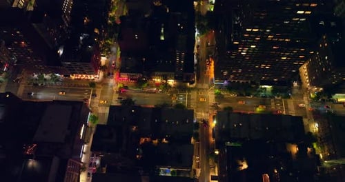 New York quarters at night time. Busy traffic on the light roads from aerial perspective.