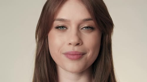 Portrait of cheerful caucasian woman in the studio. Shot with RED helium camera in 8K.