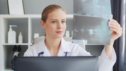 Doctor Works in the Medical Office Woman in White Coat Workplace of a Professional Female Therapist