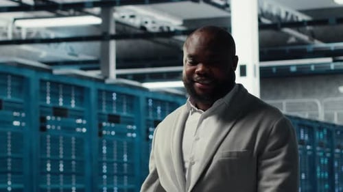 Smiling Employee Walking in High Tech Data Center