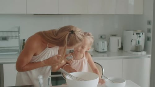 Mother and Daughter Baking Together in Kitchen