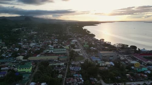 City with Buildings By Ocean Overlooking Hills with Trees