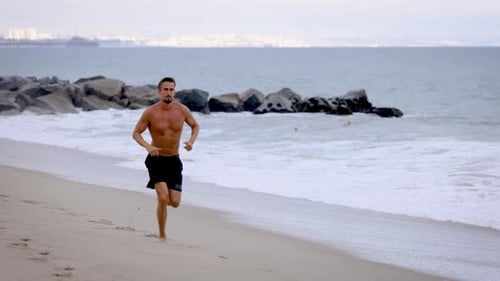 Athletic Man Exercising At The Beach