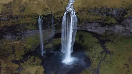 Massive Seljalandsfoss Waterfall Cascading Over Lush Green Icelandic Cliffs
