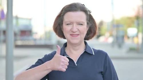 Woman Giving Thumbs Up with a Smiling Face