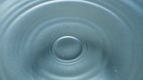 Water Droplets Impacting Tranquil Water Surface