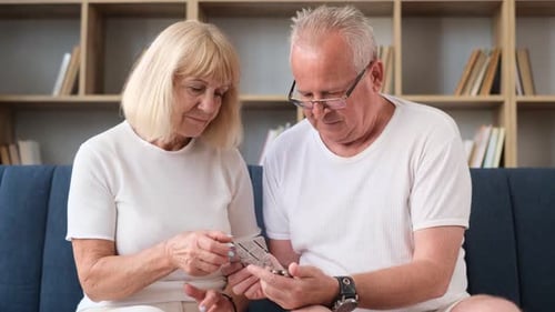 Senior Couple Taking Medication at Home