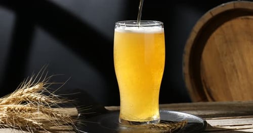 Refreshing Beer Filling Glass with Bubbles and Foam