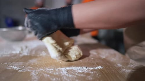 Side View Unrecognizable Woman Kneading Dough in Slow Motion in Restaurant Kitchen Indoors Caucasian