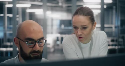 Team Collaboration: Man and Woman Working on Computer