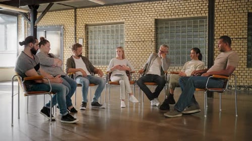Group of Individuals Sitting in Circle on Therapy Session