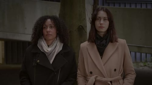 Lifestyle Portrait of Two Young Women Watching Tower Building Together