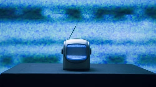 Retro TV with Static on Table in Dark Room