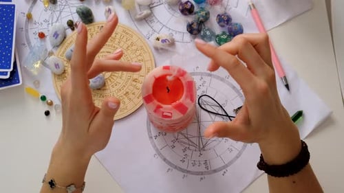 Hands Around Candle with Tarot Cards and Crystals
