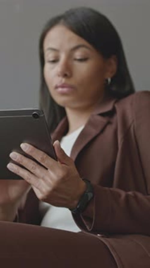 Young Adult Woman Using Tablet Indoors