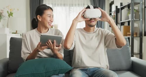 Couple Enjoys VR Headset and Tablet at Home