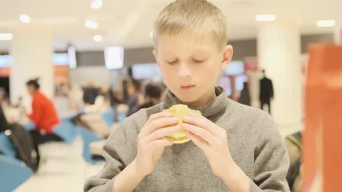 Blond Boy Eats a Burger