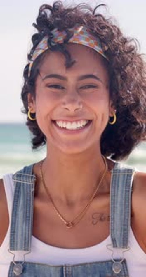 Girl, beach and smile for holiday, portrait and happiness for travel, vacation and nature of water