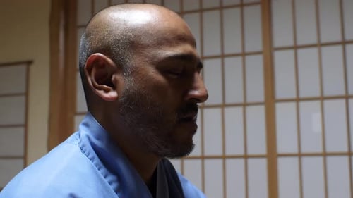 Man Meditating Peacefully with Eyes Closed Indoors