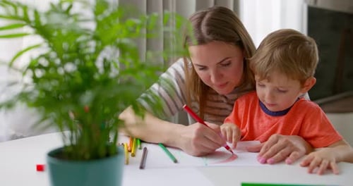Mother and Child Drawing Together at Home