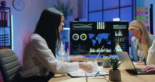 Diverse Team Collaborating on Data in Modern Office