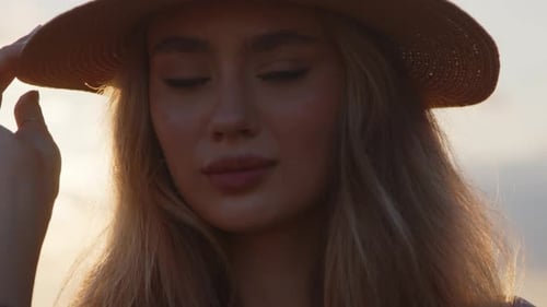 Woman in Hat with Blonde Hair Posing in Sunlight