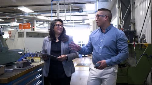 Manager Giving Tour to Visitor in Manufacturing Plant 10 Seconds or Greater