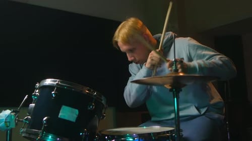 Drummer Plays Drums in Dark Music Studio