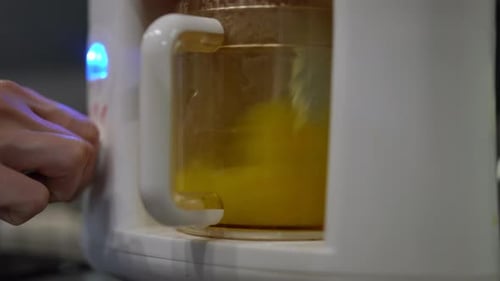Blending Yellow Mixture in White Kitchen Appliance