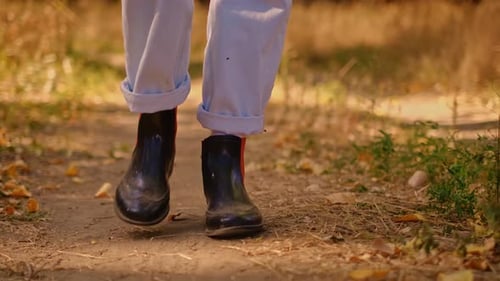 teenage tourist walking through the forest in the park, travel concept, close-up of a person's leg w