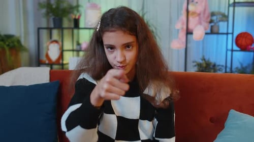 Preteen Girl Smiling Pointing to Camera Choosing Lucky Winner Indicating Inviting Approve at Home