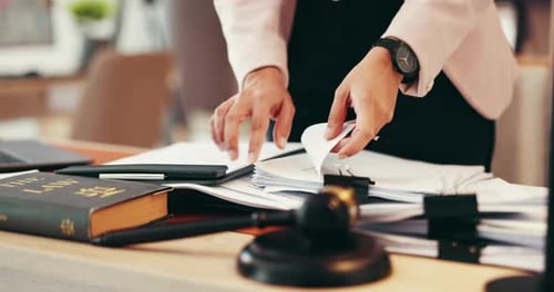 Person, hands or lawyer with paperwork for legal advice, testimonial or statements at office desk