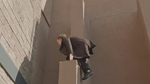 Person Performing Parkour Stunt on Wall