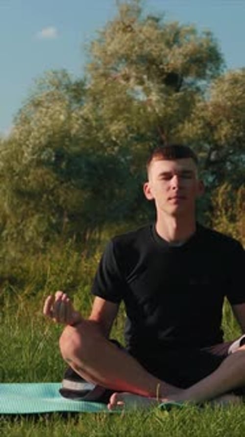 Young Adult Meditating in a Park