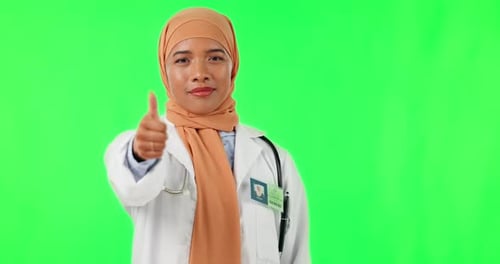 Muslim woman, doctor and thumbs up in confidence on green screen for success against a studio